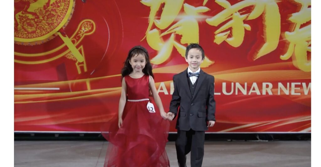 Young contestant and escort on stage at Princess Of Asia Pageant Main Competition
